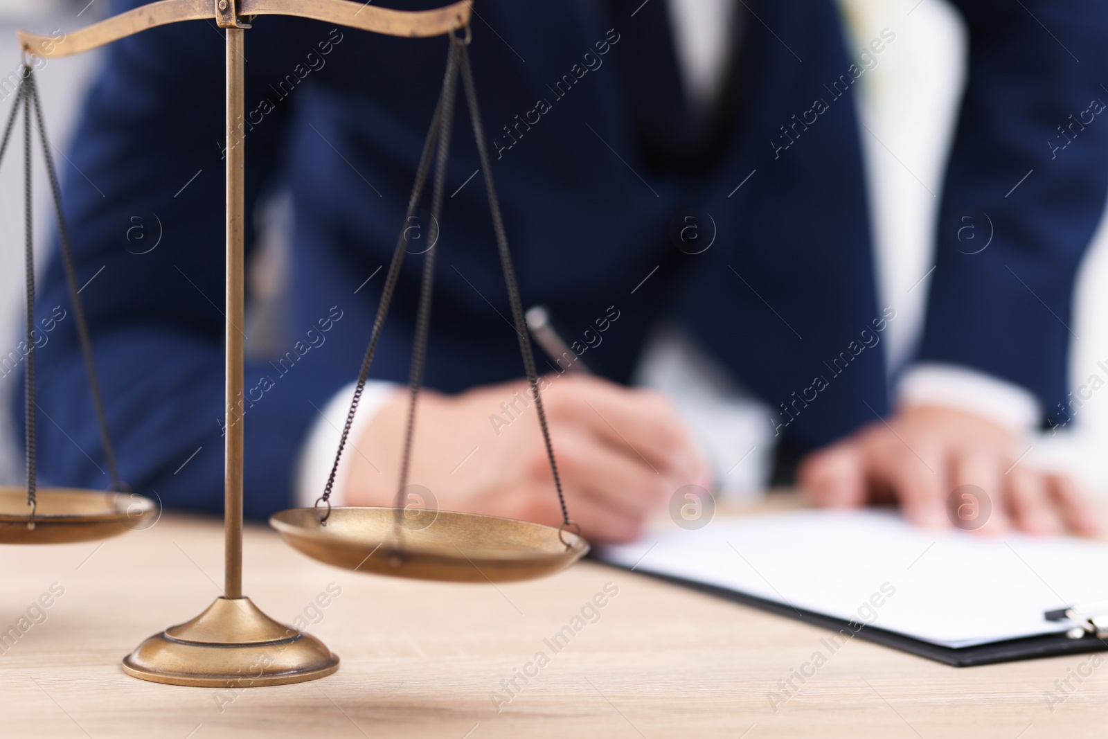 Judge working and scales on desk indoors, selective focus Photo of Judge working and scales on desk indoors, selective focus