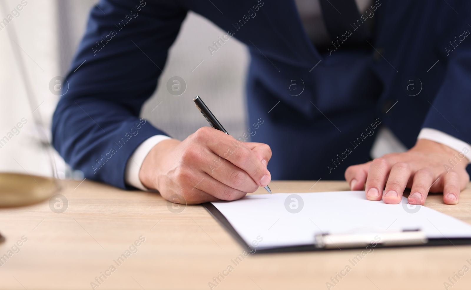 Judge working at wooden desk indoors, closeup Photo of Judge working at wooden desk indoors, closeup