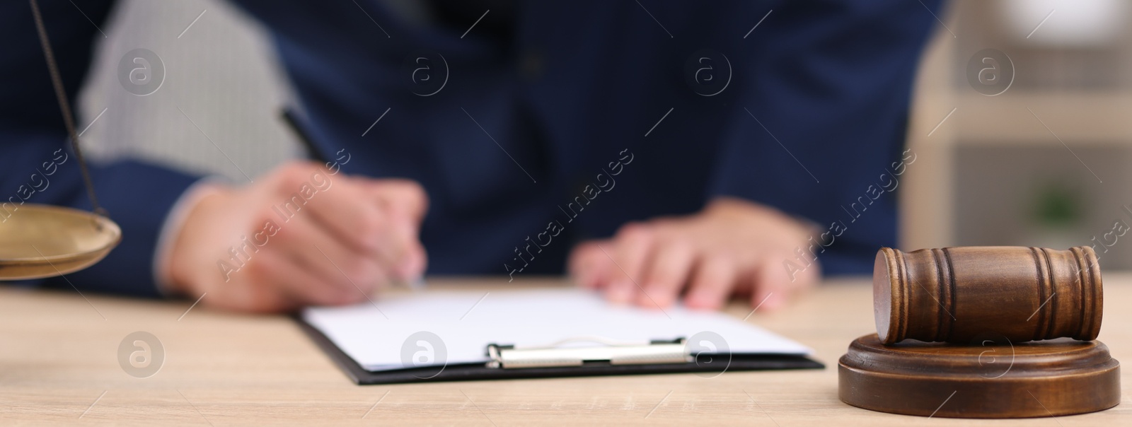 Judge working at wooden desk indoors, closeup Photo of Judge working at wooden desk indoors, closeup
