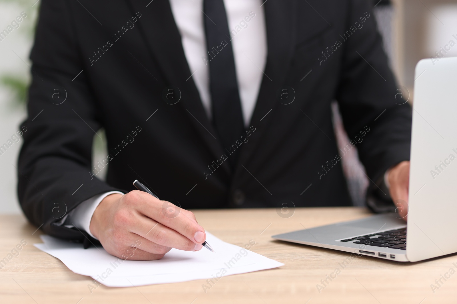 Judge working at wooden desk indoors, closeup Photo of Judge working at wooden desk indoors, closeup