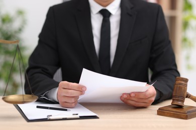 Photo of Judge working at wooden desk indoors, closeup