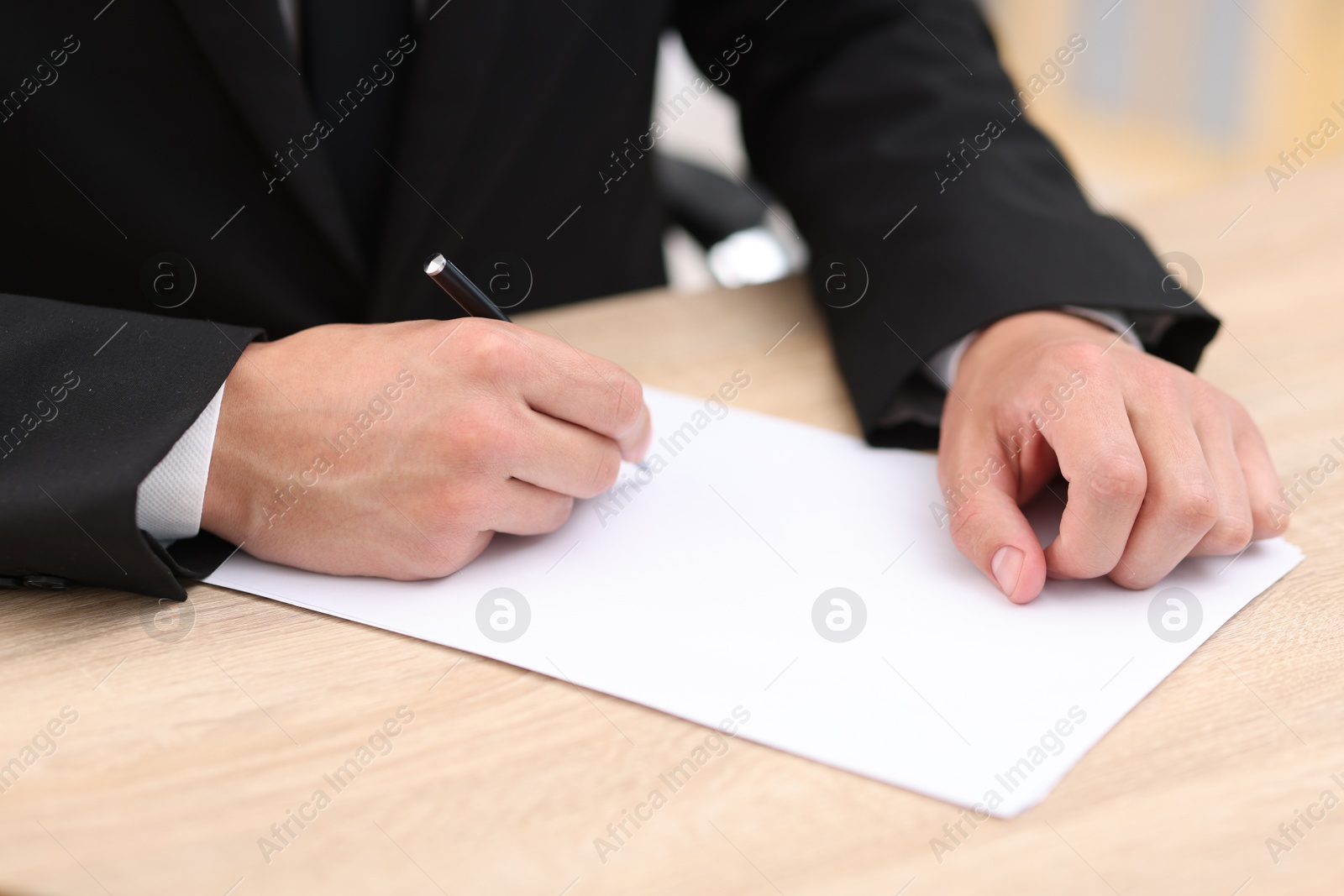 Judge working at wooden desk indoors, closeup Photo of Judge working at wooden desk indoors, closeup