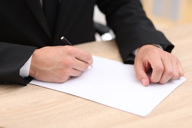 Photo of Judge working at wooden desk indoors, closeup