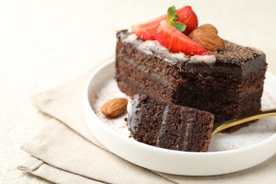 Photo of Piece of delicious chocolate cake with strawberry and almonds on table, closeup. Space for text