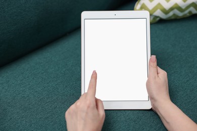 Photo of Woman with modern tablet at home, closeup. Space for text