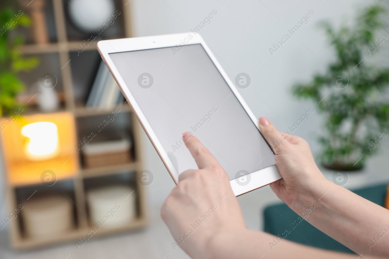Woman with modern tablet at home, closeup Photo of Woman with modern tablet at home, closeup