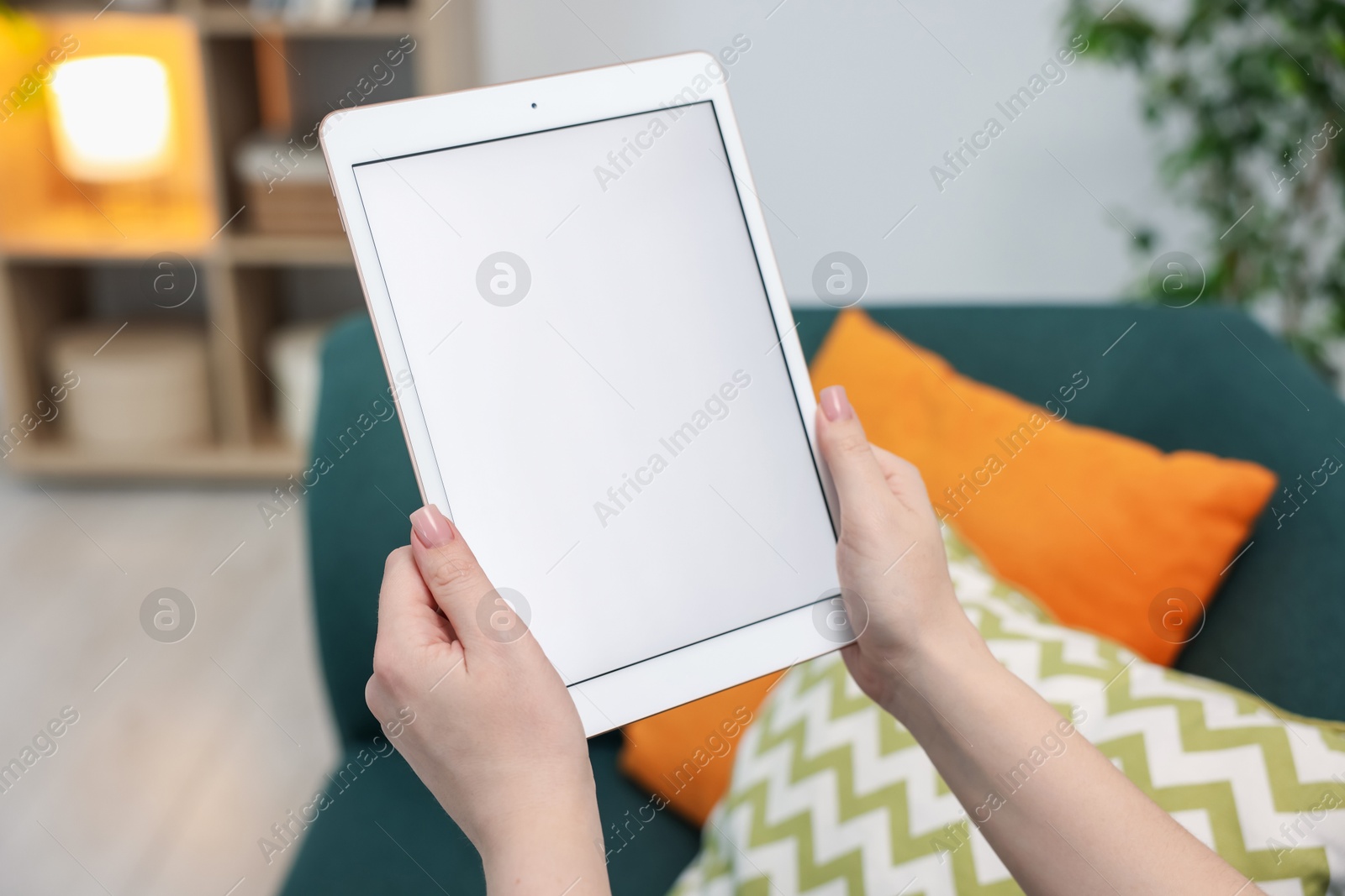 Woman with modern tablet at home, closeup Photo of Woman with modern tablet at home, closeup