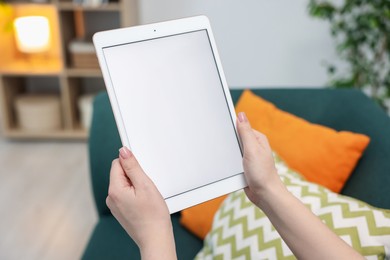 Photo of Woman with modern tablet at home, closeup