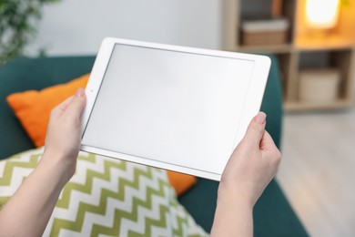 Photo of Woman with modern tablet at home, closeup