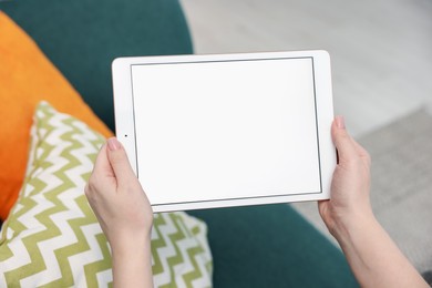 Photo of Woman with modern tablet at home, closeup