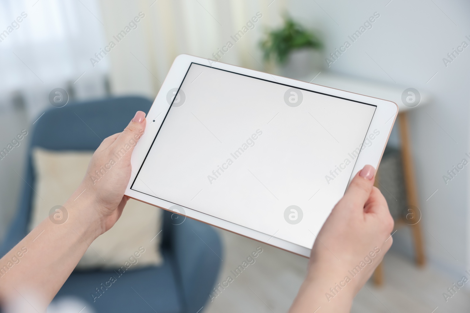Woman with modern tablet at home, closeup Photo of Woman with modern tablet at home, closeup