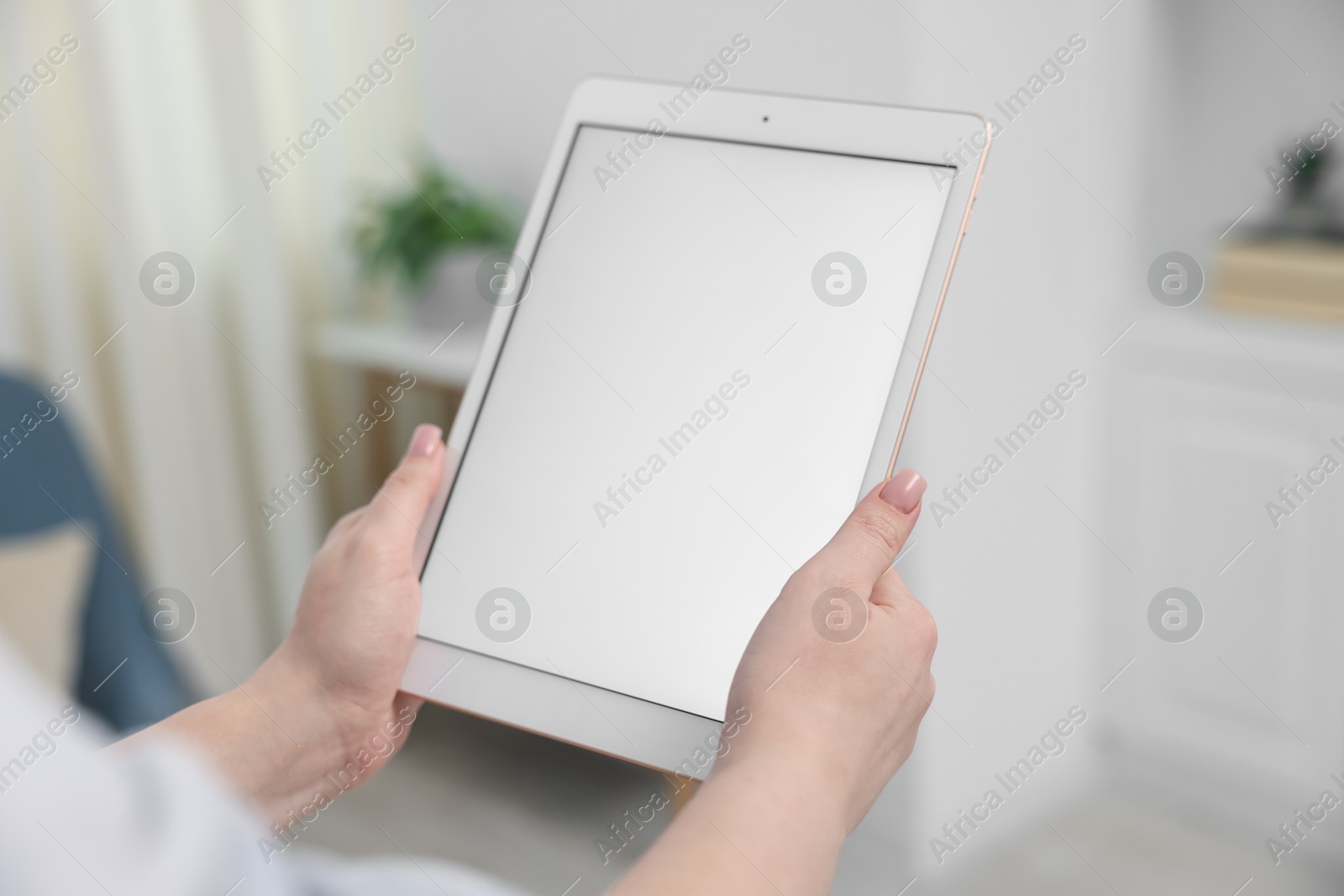 Woman with modern tablet at home, closeup Photo of Woman with modern tablet at home, closeup