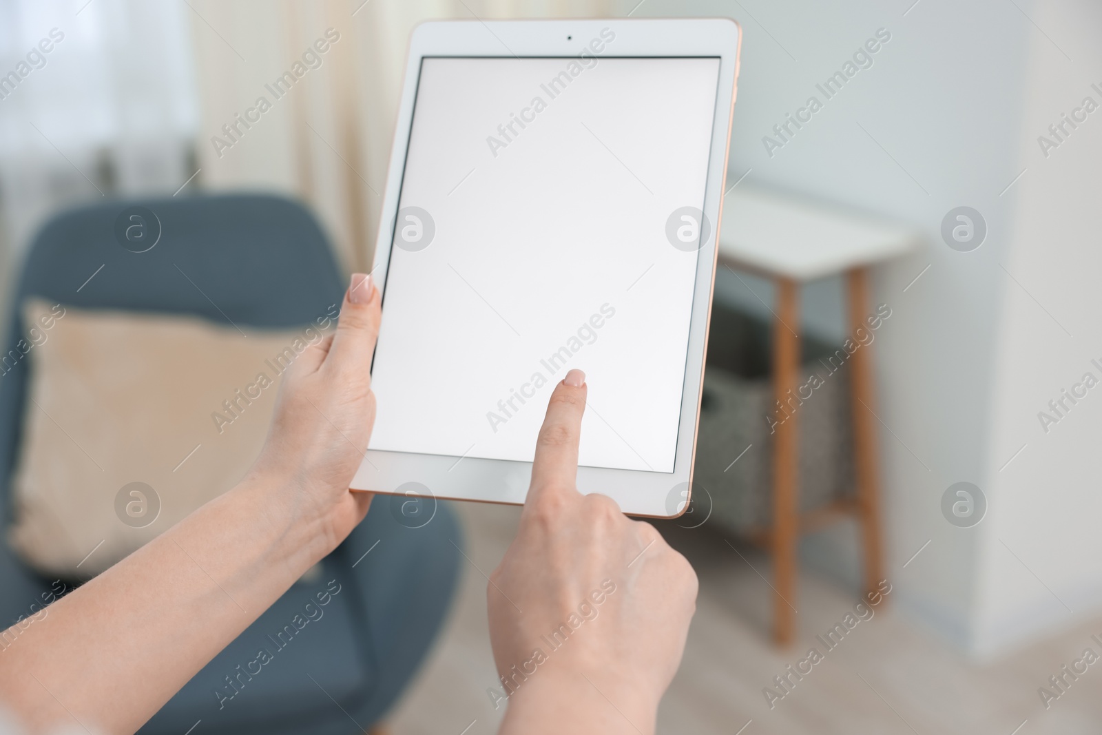Woman with modern tablet at home, closeup Photo of Woman with modern tablet at home, closeup