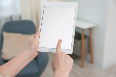 Photo of Woman with modern tablet at home, closeup