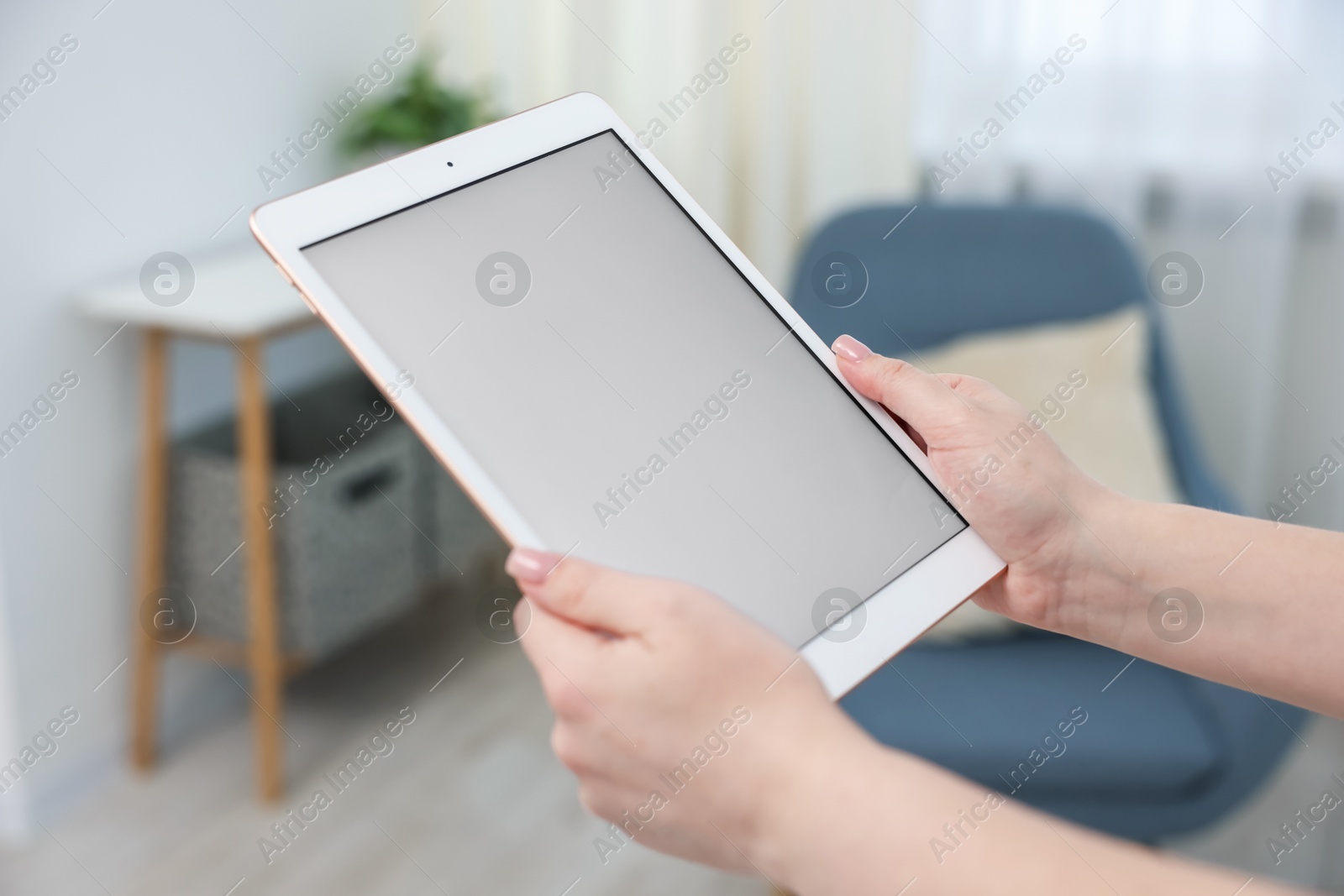 Woman with modern tablet at home, closeup Photo of Woman with modern tablet at home, closeup