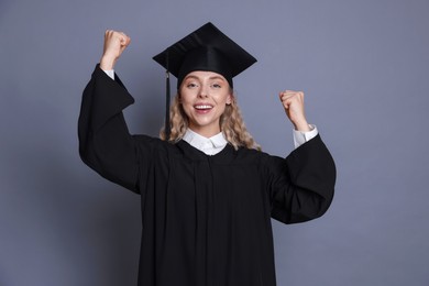 Photo of Happy student after graduation on grey background