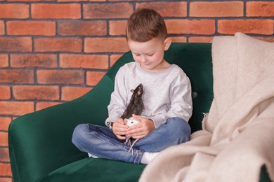 Photo of Little boy with his pet rats on sofa at home