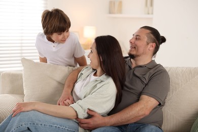 Photo of Parents with their son at home. Lovely family