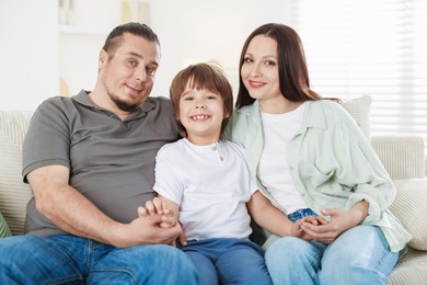 Photo of Parents with their son at home. Lovely family