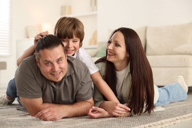 Photo of Parents with their son on floor at home