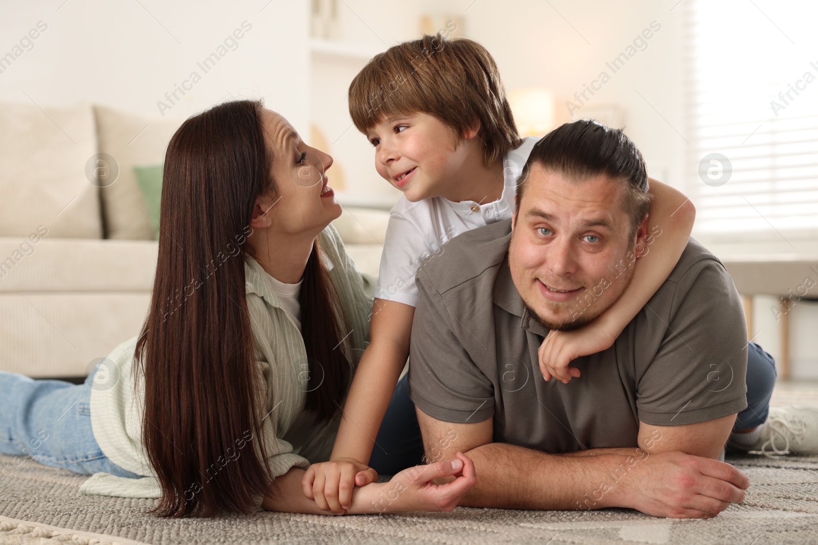 Parents with their son on floor at home Photo of Parents with their son on floor at home