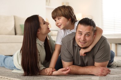 Photo of Parents with their son on floor at home