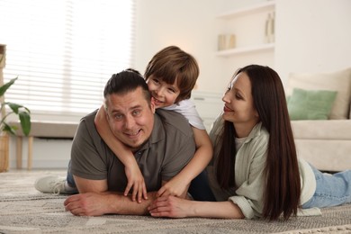 Photo of Parents with their son on floor at home