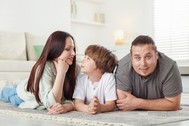 Photo of Parents with their son on floor at home