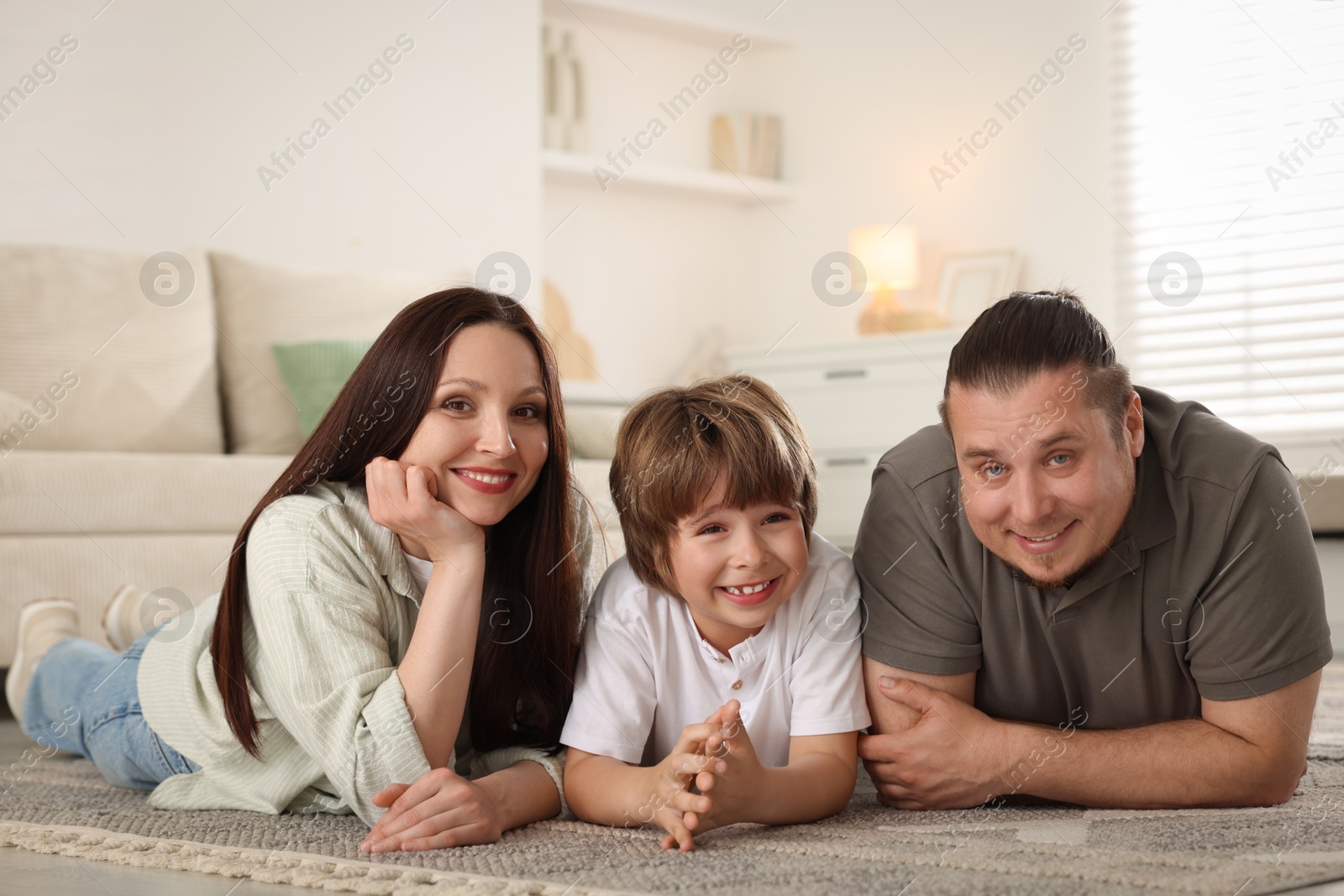 Parents with their son on floor at home Photo of Parents with their son on floor at home