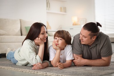 Photo of Parents with their son on floor at home