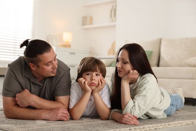 Photo of Parents with their son on floor at home