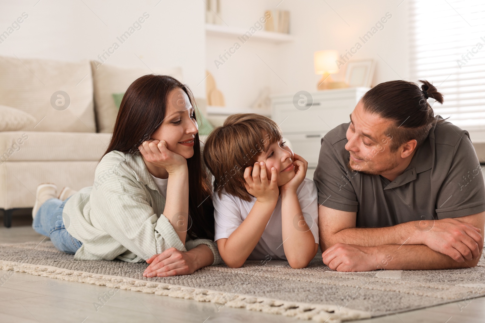 Parents with their son on floor at home Photo of Parents with their son on floor at home
