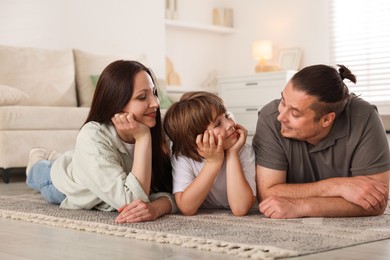 Photo of Parents with their son on floor at home