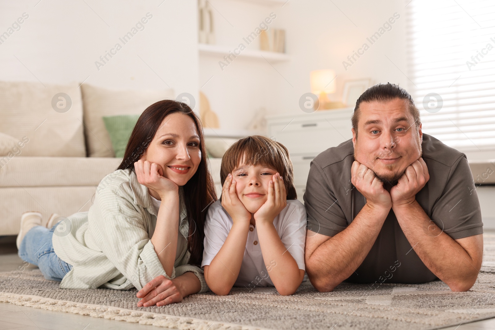 Parents with their son on floor at home Photo of Parents with their son on floor at home