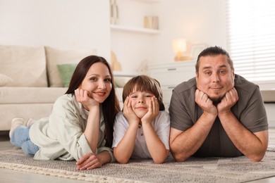 Photo of Parents with their son on floor at home