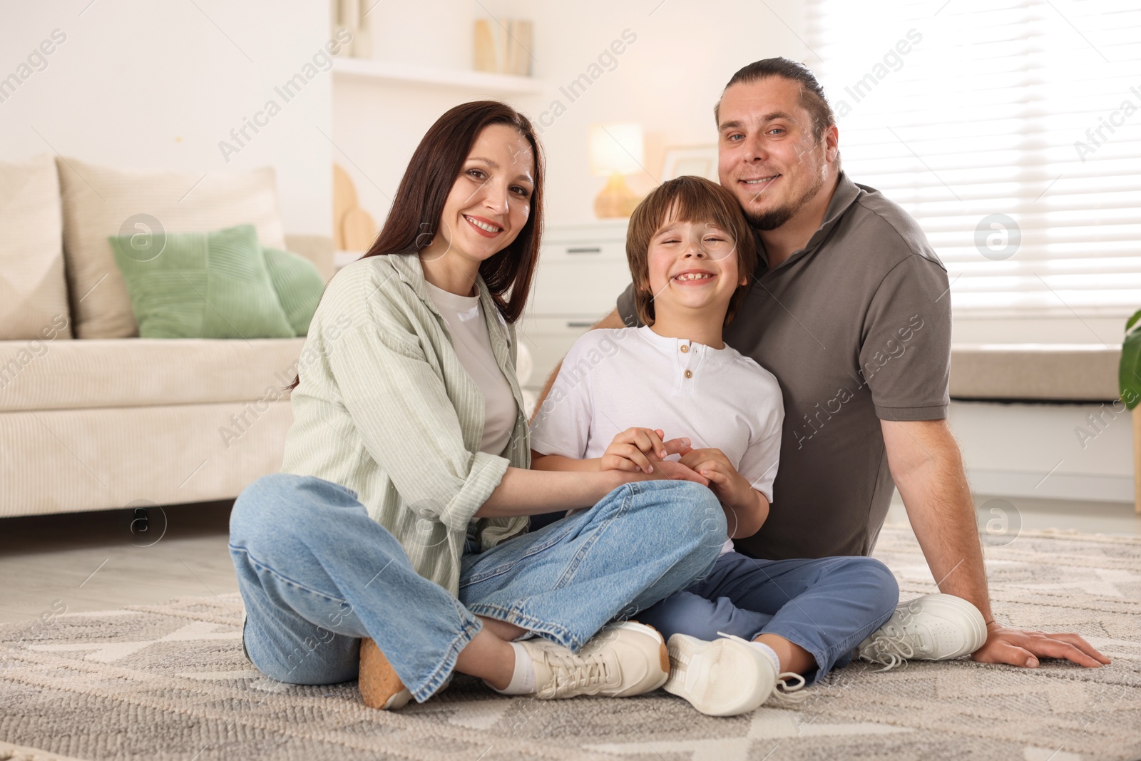 Parents with their son on floor at home Photo of Parents with their son on floor at home
