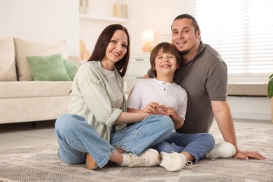 Photo of Parents with their son on floor at home