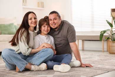 Photo of Parents with their son on floor at home, space for text