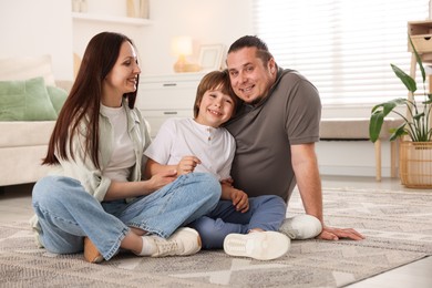 Photo of Parents with their son on floor at home