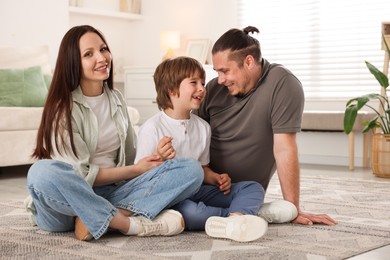 Photo of Parents with their son on floor at home