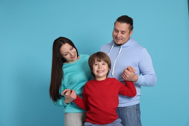 Photo of Portrait of happy family on light blue background