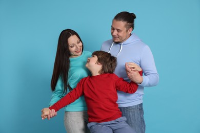 Photo of Portrait of happy family on light blue background