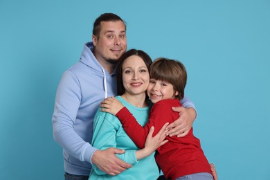 Photo of Portrait of happy family on light blue background