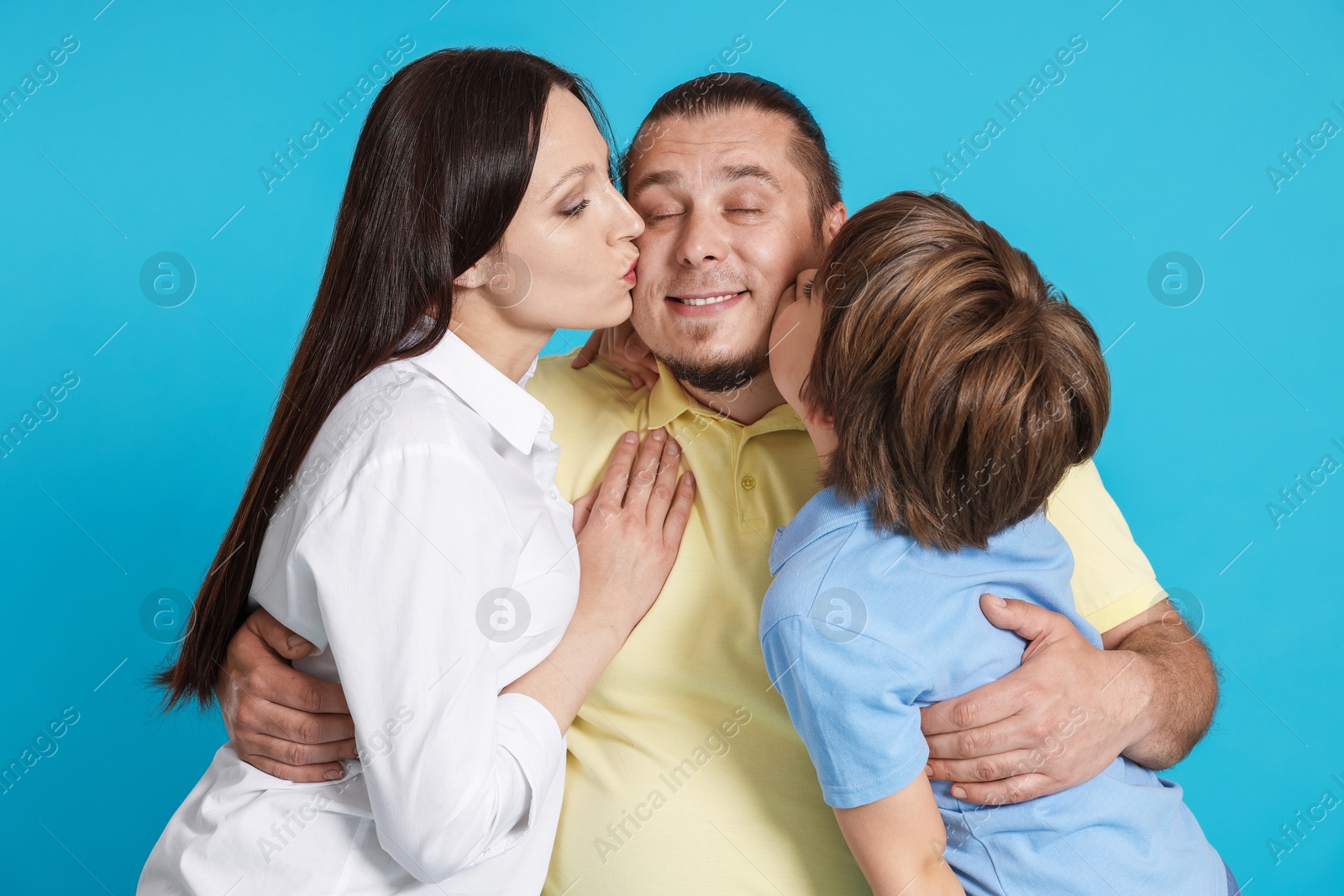 Portrait of happy family on light blue background Photo of Portrait of happy family on light blue background