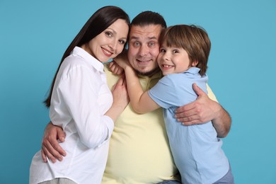 Photo of Portrait of happy family on light blue background