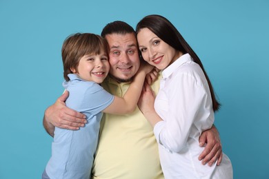 Photo of Portrait of happy family on light blue background