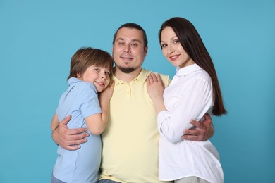 Photo of Portrait of happy family on light blue background