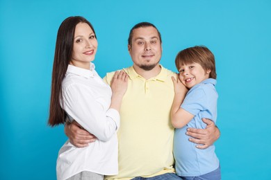 Photo of Portrait of happy family on light blue background