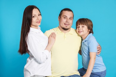 Photo of Portrait of happy family on light blue background