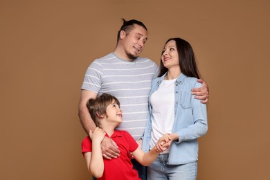 Photo of Portrait of happy family on brown background